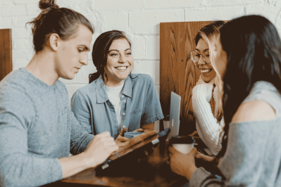 happy people are planning wedding photography on a table